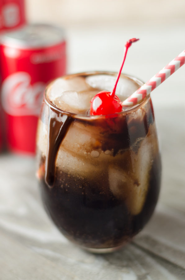 Chocolate Covered Cherry Coke Cocktails are our newest favorite way to celebrate! Click the pin to get this recipe! Trust me you won't want to miss out on this great cocktail Recipe AD